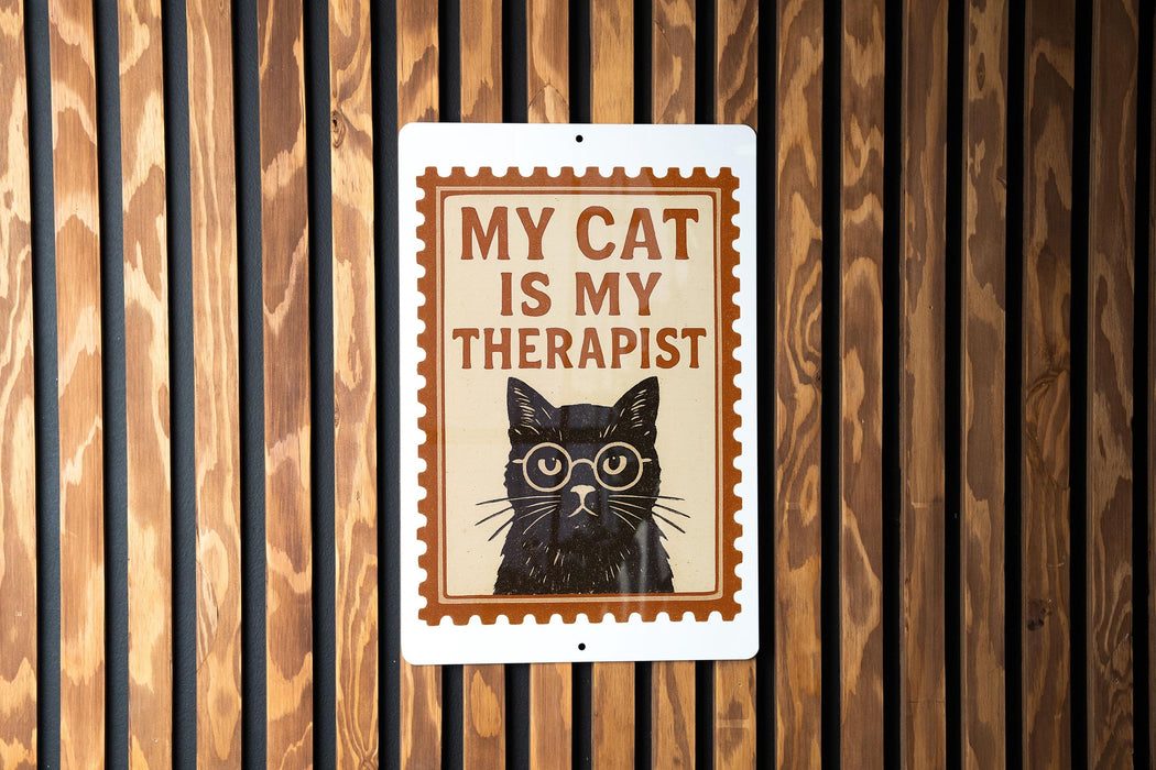 A sign with the text "MY CAT IS MY THERAPIST" and an illustration of a cat wearing glasses.