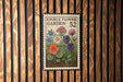 a vintage-style edible flower garden postage stamp, which is mounted on a wooden wall.
