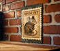 A wooden table with a brick wall in the background, and a framed illustration of a mouse on the wall.