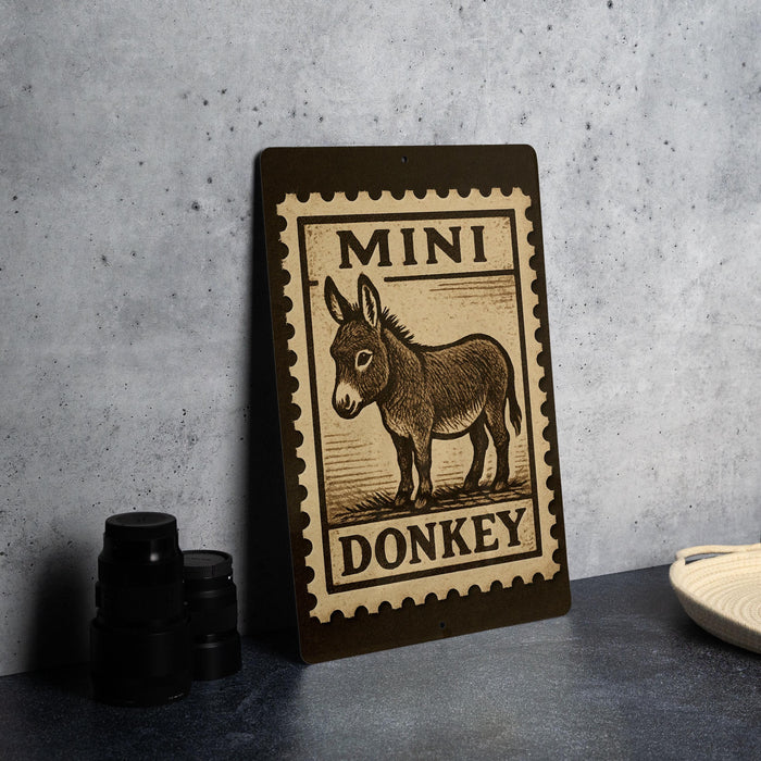 a sign with a donkey illustration, placed on a countertop next to some black camera lenses.