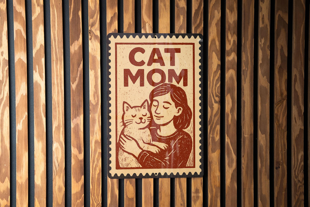 A sign with the text "CAT MOM" and an illustration of a woman holding a cat.