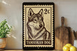 A framed image of a tamaskan dog, a breed of wolf, is displayed on a shelf next to a wooden cutting board and some lemons.