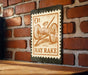 a sign with a vintage-style illustration of a horse-drawn carriage, mounted on a brick wall.