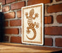 a wooden table with a framed picture of a lizard on it, mounted on a brick wall.