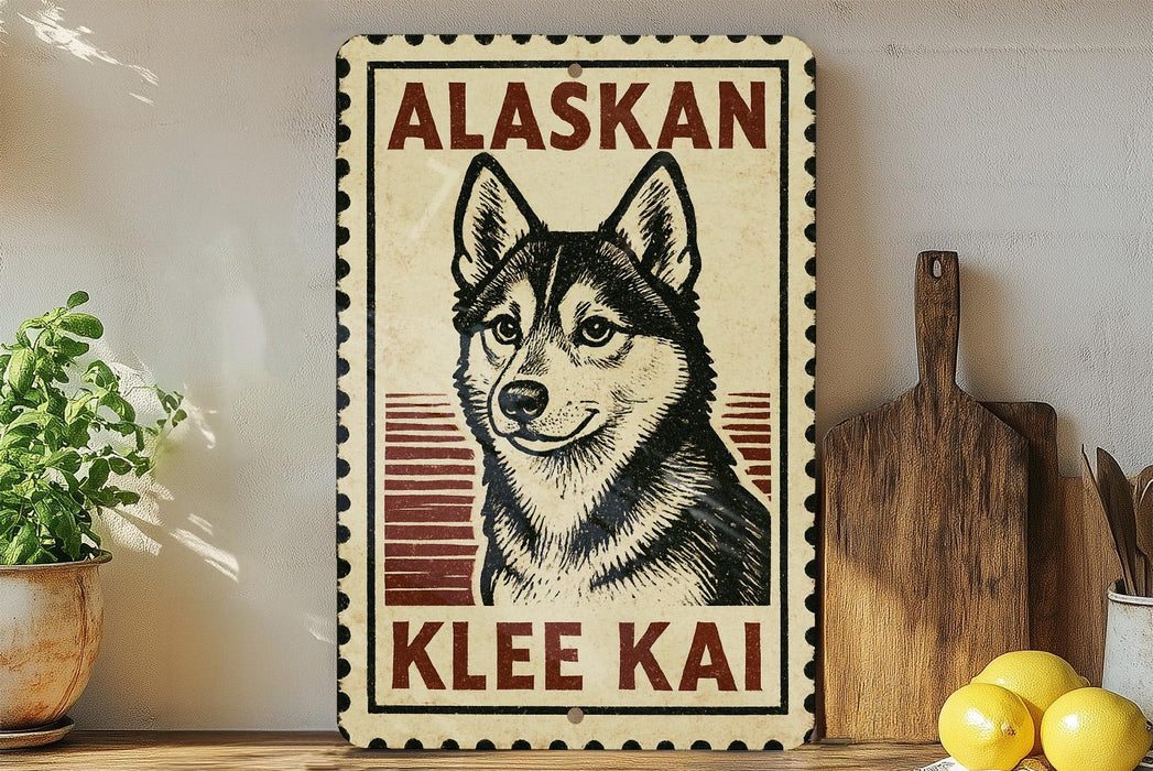 A vintage-style sign featuring a black and white illustration of a husky dog, with the text "ALASKAN KLEE KAI" prominently displayed.