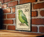 A vintage-style postage stamp featuring a green parrot, with the number 50 printed on it, is displayed on a brick wall.