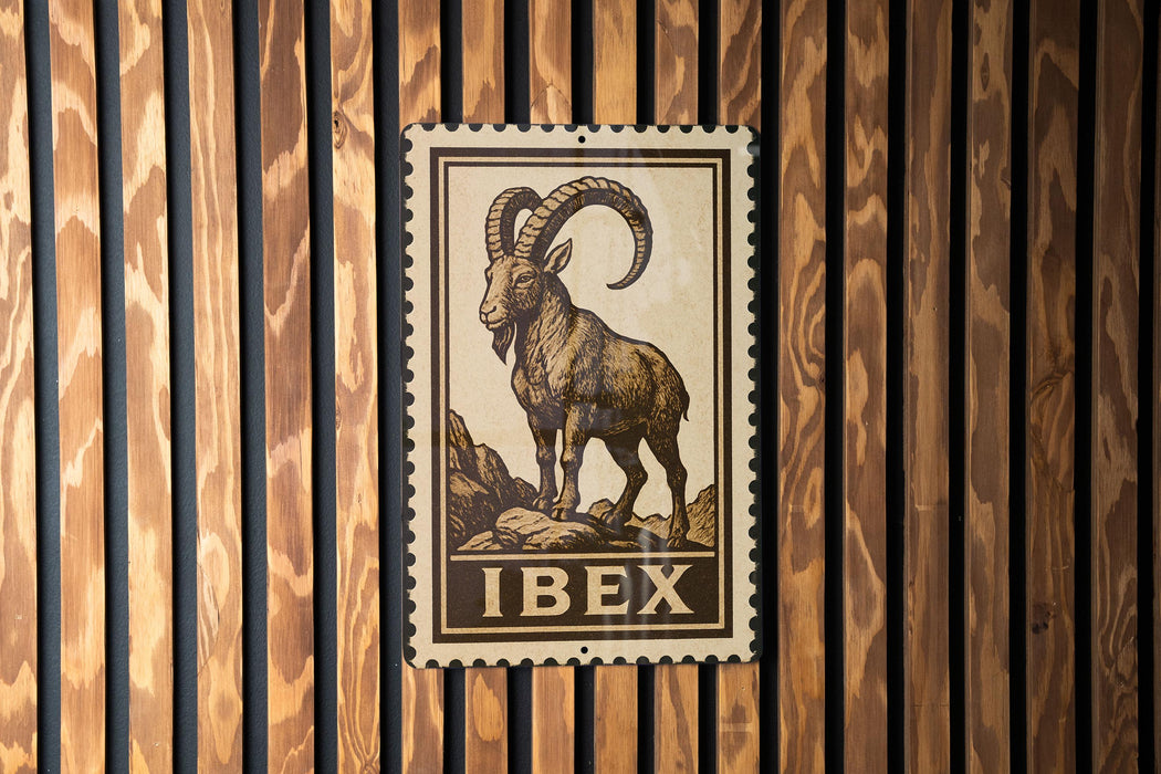 a metal stamp with a depiction of a ram, mounted on a wooden wall.