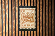 a sign with the text "Ot Hay Rake" on it, which is mounted on a wooden wall.