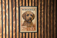 A stamp featuring a dog's head on a wooden background.