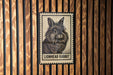 A lionhead rabbit stamp is displayed on a wooden wall.