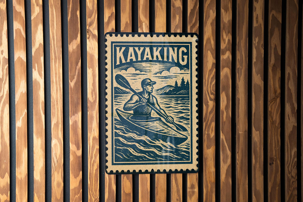 A vintage-style metal sign with a kayaker illustration, mounted on a wooden wall.