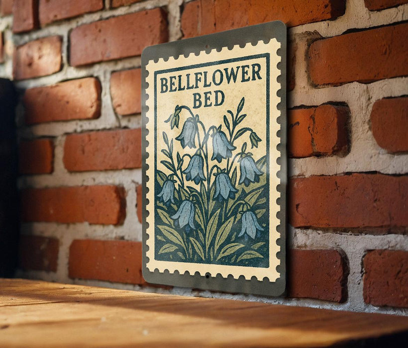 A metal sign with a floral design hangs on a brick wall, featuring the text "BELFLOWER BED" and a depiction of blue bell-shaped flowers.