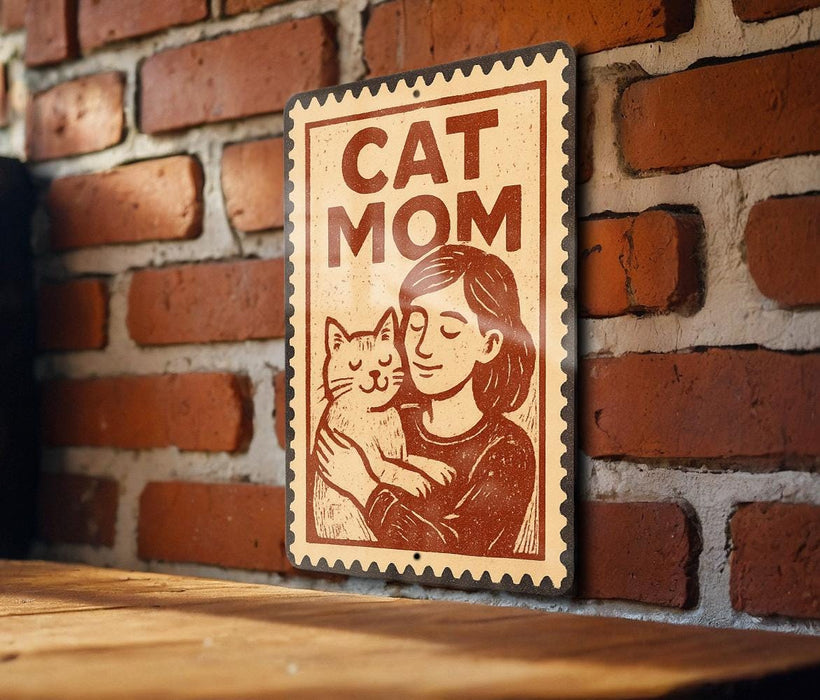 A sign with the text "CAT MOM" and an illustration of a woman holding a cat.