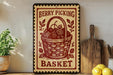 A vintage-style sign with the text "Berry Picking Basket" and an illustration of a basket filled with berries, placed on a wooden shelf next to a cutting board and a potted plant.