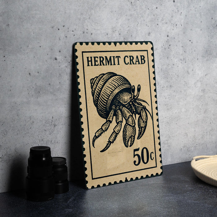 A ceramic stamp depicting a hermit crab, with the text "HERMIT CRAB" and the denomination "50c" printed on it.