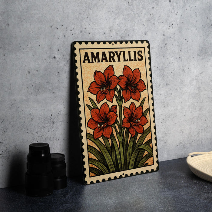A metal sign with a floral design and the word "AMARYLLIS" printed on it, placed on a countertop next to some black camera lenses.