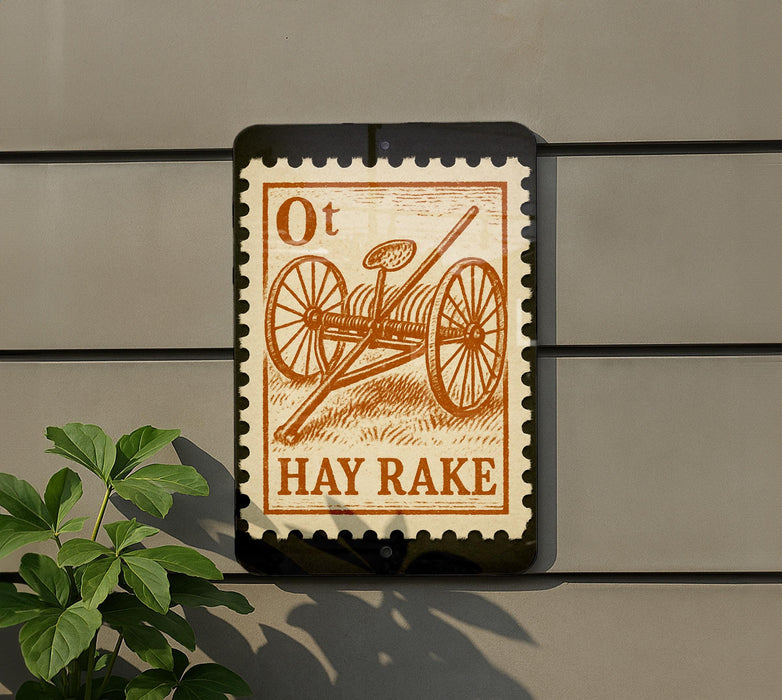 a sign with an illustration of a hay rake on it, mounted on a wall.