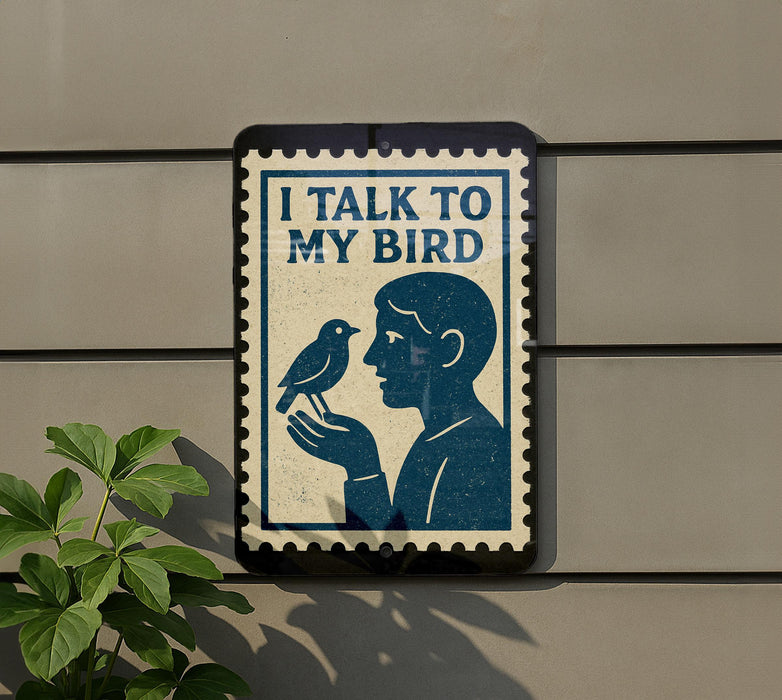 a sign with a blue background and a black border, depicting a man holding a bird. The sign has the text "I TALK TO MY BIRD" written on it.
