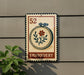 a sign for an embroidery shop, with a floral design and the word "Embroidery" written on it.