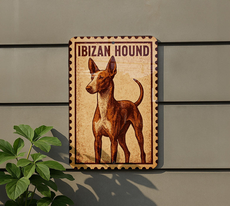 a brown and white hound dog standing on a wall, with a plant to the left of the dog.