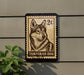 A postage stamp featuring a close-up of a dog's face, with the text "TAMASKAN DOG" printed below it.