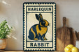 A vintage-style sign featuring a cartoon rabbit, with the text "HARLEQUIN RABBIT" displayed prominently.