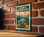 A vintage-style metal sign with a scenic viewpoint illustration is mounted on a brick wall.