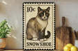 A 10c stamp-like sign featuring a Siamese cat, with the text "SNOWSHOE" below the illustration.