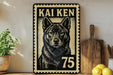 A metal sign with a black and white illustration of a dog, along with the text "KAI KEN 75" printed on it, is displayed on a shelf next to a wooden cutting board and some potted plants.