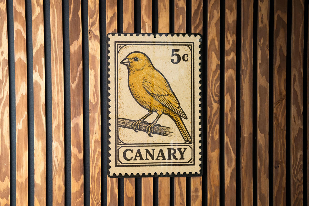 A vintage-style postage stamp featuring a yellow canary perched on a branch, mounted on a wooden wall.