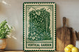 a green and white sign with a decorative border, displaying a lush illustration of a vertical garden, placed on a wooden shelf next to a wooden cutting board and a potted plant.