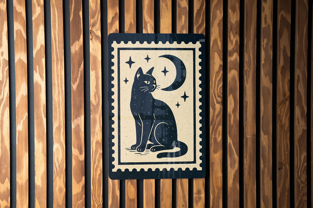 A black cat sitting on its hind legs with a crescent moon and stars above it, depicted on a wooden surface.