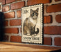 A 10c stamp-like sign featuring a cat illustration is mounted on a brick wall.
