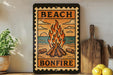 a sign that reads "BEACH BONFIRE" with a fire pit illustration, surrounded by various kitchen utensils and a potted plant.