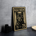 A metal stamp with a black and white illustration of a dog, along with the text "KAI KEN 75" printed on it, is displayed on a table.