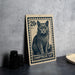 A 20 cent postage stamp featuring a cat illustration, placed on a table next to some black camera lenses.