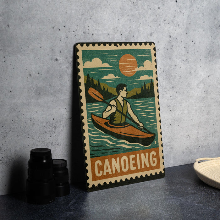 A vintage-style metal sign featuring a man kayaking in a river, with a sun and clouds in the background.