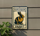 a sign with a rabbit illustration, mounted on a wall.