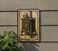 a vintage-style stove with a teapot on top, displayed on a wall.