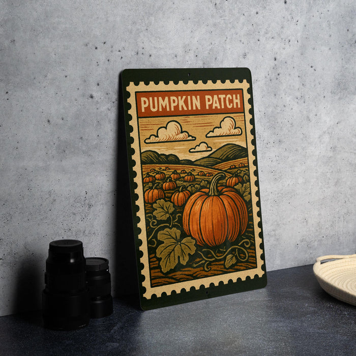 A metal sign with a pumpkin patch illustration on it, placed on a table next to some black camera lenses.
