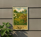 A metal sign with a painting of a naturalistic garden, featuring flowers and plants, is mounted on a wall.
