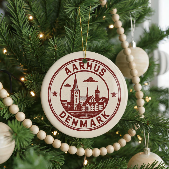 A Christmas tree decorated with ornaments, including a circular ornament with a graphic of a city and the text "AARHUS DENMARK".