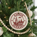 A Christmas tree decorated with ornaments, including a circular ornament with a graphic of a city and the text "AARHUS DENMARK".