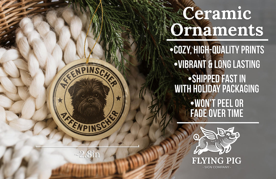 Ceramic ornaments, featuring a ceramic ornament with a dog image and text, placed in a wicker basket with pine branches.