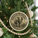 A round ornament on a Christmas tree featuring an elephant image, with the text "African Elephant" around the edge.