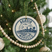 A circular ornament on a Christmas tree, featuring a cityscape and palm trees, with the text "AGADIR MOROCCO" printed on it.