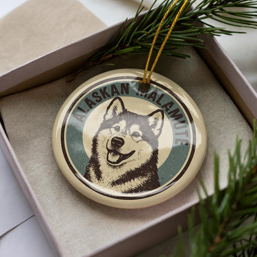 A circular ornament featuring a close-up image of a husky dog, with the text "Alaskan Malamute" written around the edge.