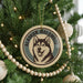 A Christmas tree decorated with ornaments, including a circular ornament featuring a picture of a husky dog and the text "Alaskan Malamute".
