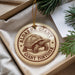 A circular ornament with a tortoise illustration and the text "ALDABRA GIANT TORTOISE" printed on it, hanging from a string.