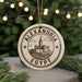 A circular ornament with the text "ALEXANDRIA EGYPT" and an illustration of a castle, hanging from a string.